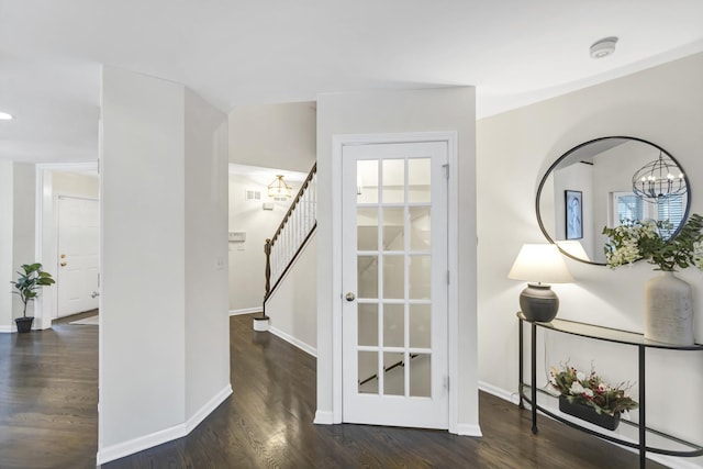 interior space featuring a chandelier and dark wood-type flooring