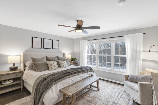 bedroom featuring hardwood / wood-style floors, ceiling fan, and crown molding