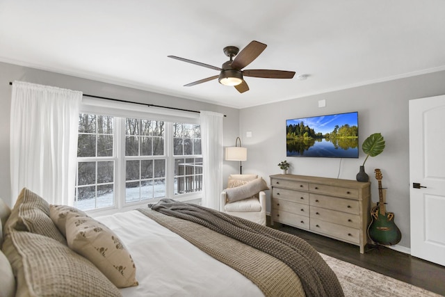 bedroom with ceiling fan, dark hardwood / wood-style flooring, and crown molding