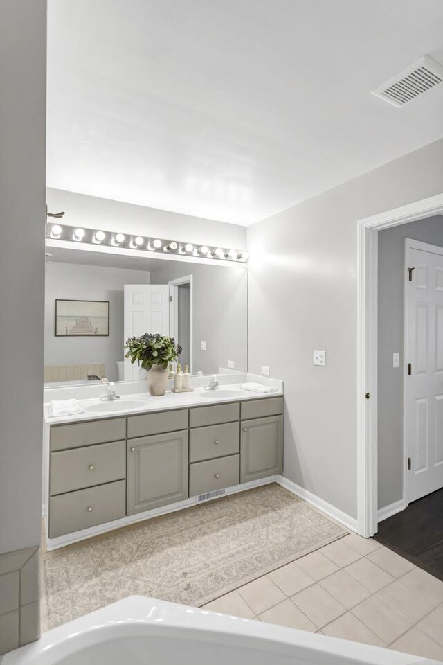 bathroom with tile patterned flooring and vanity