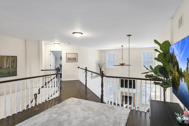 corridor with dark hardwood / wood-style flooring