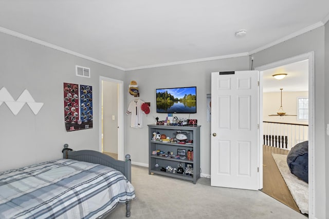 bedroom with carpet floors and crown molding