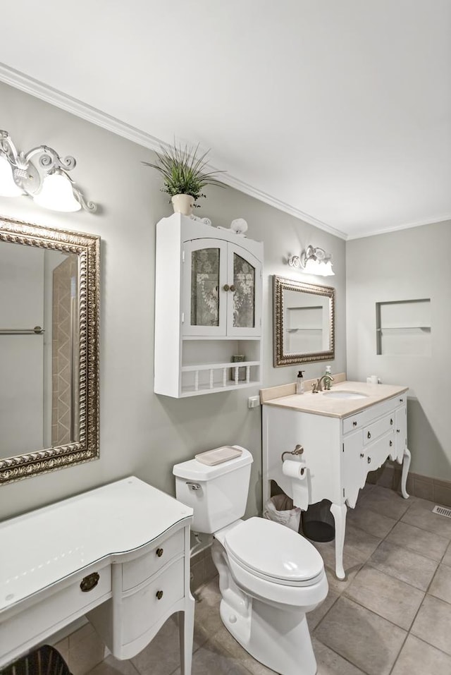 bathroom with vanity, toilet, and ornamental molding