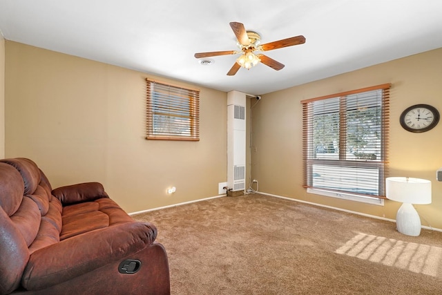 living area with ceiling fan and carpet flooring