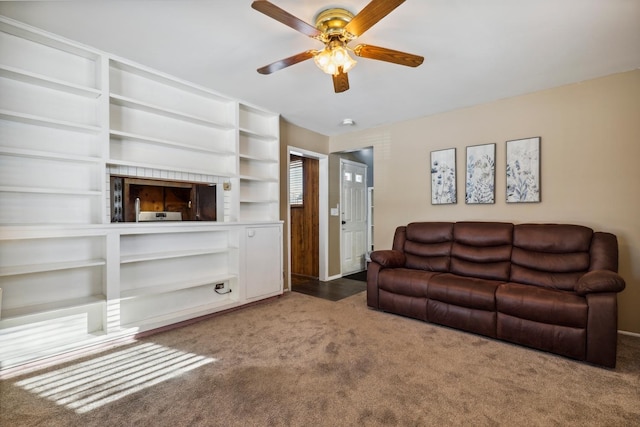 carpeted living room with ceiling fan