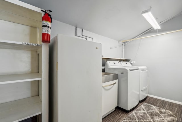 laundry room featuring washer and dryer and dark carpet