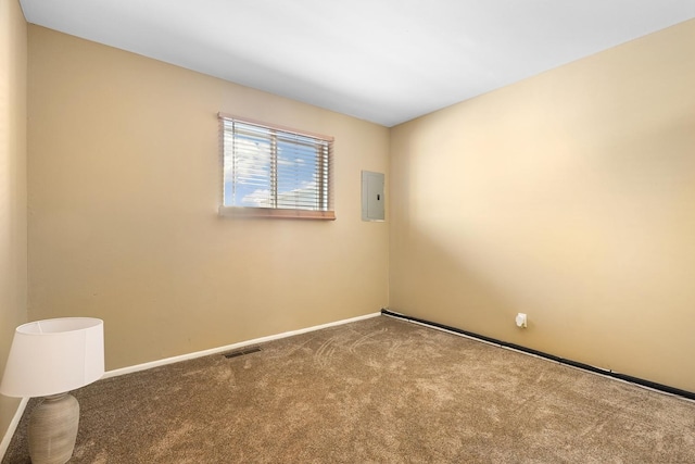 unfurnished room featuring electric panel and carpet