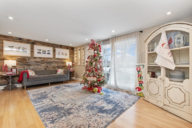 living room with wood walls and light hardwood / wood-style floors