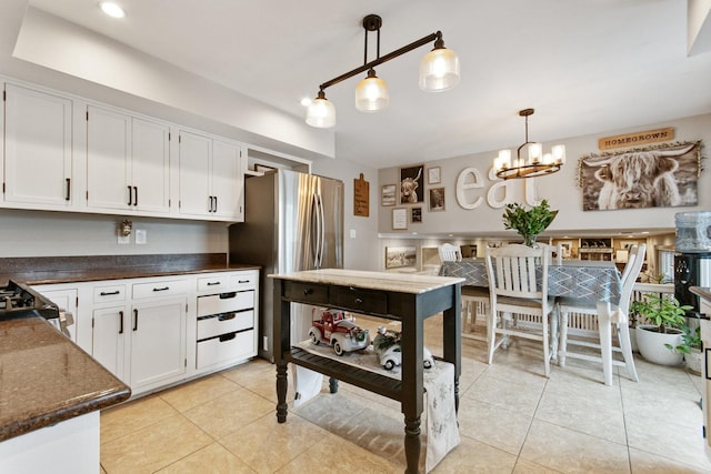 kitchen featuring white cabinetry, decorative light fixtures, and an inviting chandelier