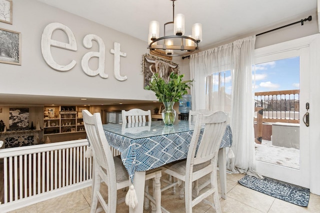 tiled dining space with an inviting chandelier