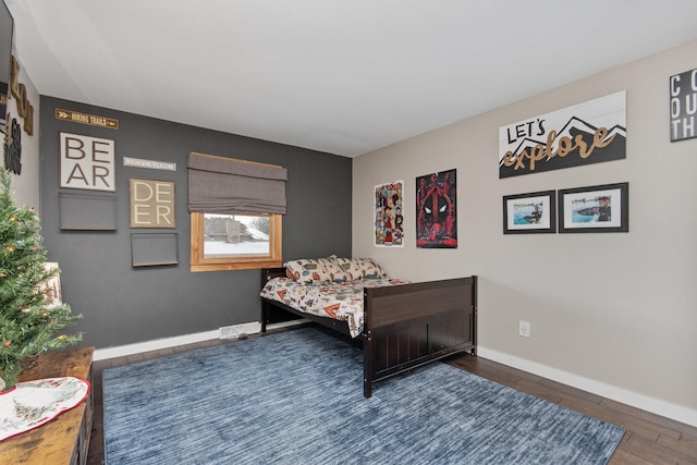 bedroom with dark hardwood / wood-style floors