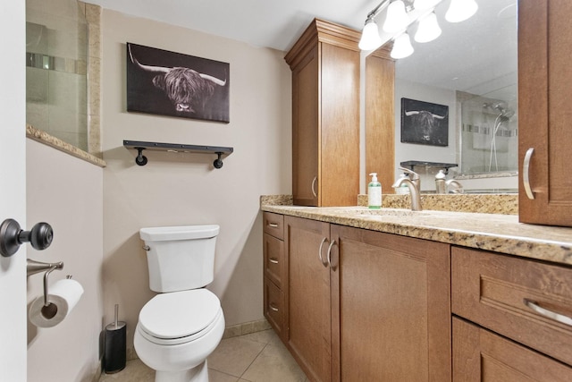 bathroom featuring tile patterned flooring, vanity, toilet, and an enclosed shower