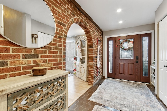 tiled entryway with brick wall