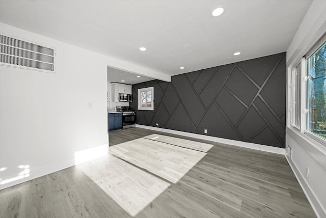 empty room featuring beam ceiling and hardwood / wood-style flooring