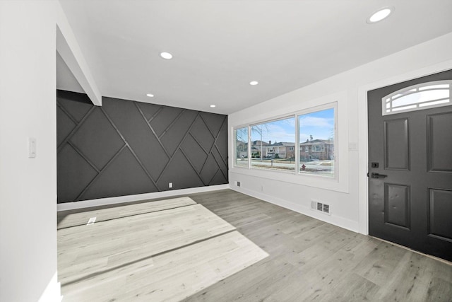 foyer entrance with light wood-type flooring