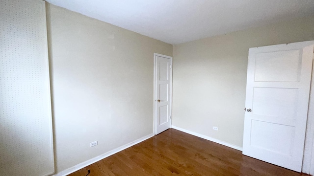 empty room featuring dark wood-type flooring