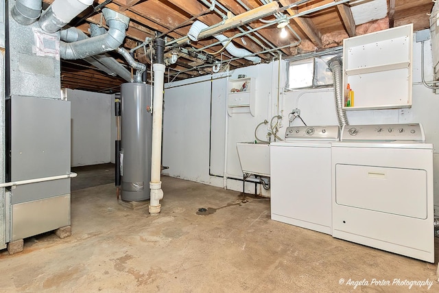 basement featuring gas water heater and washer and clothes dryer