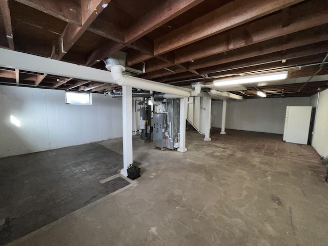 basement with water heater and heating unit