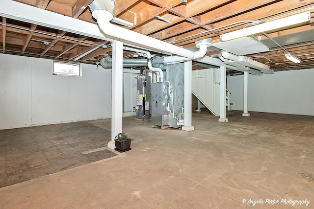 basement with water heater and heating unit