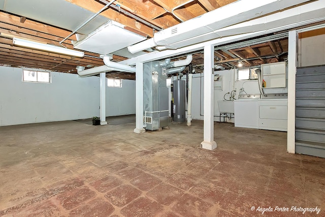 basement featuring water heater and washer and dryer