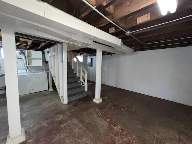 basement featuring electric panel and independent washer and dryer