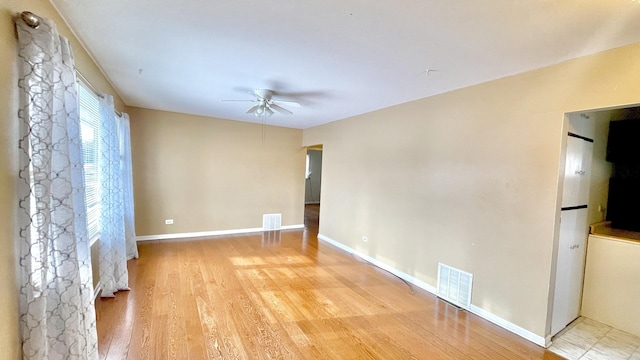 unfurnished room featuring ceiling fan and light hardwood / wood-style floors