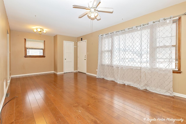 spare room with wood-type flooring, plenty of natural light, and ceiling fan