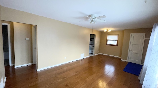 spare room featuring ceiling fan and dark hardwood / wood-style floors