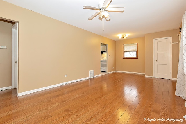 spare room featuring ceiling fan and hardwood / wood-style floors