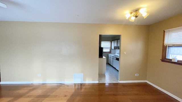 spare room with light wood-type flooring