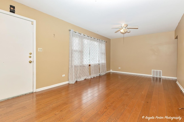 empty room with wood-type flooring and ceiling fan