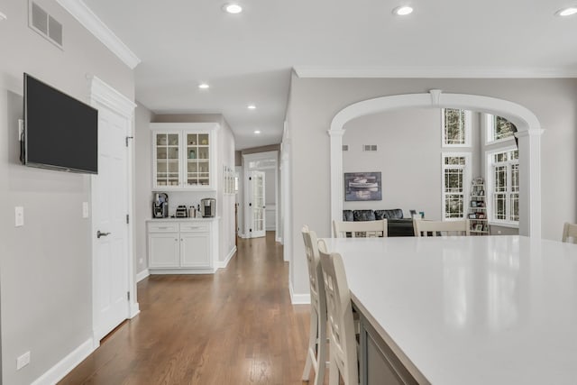 dining space with crown molding and dark hardwood / wood-style floors