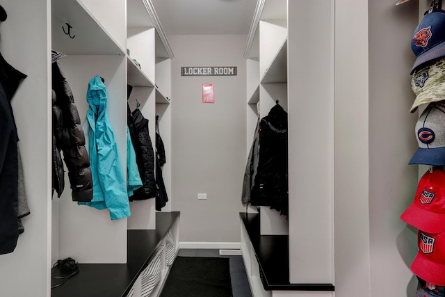 mudroom with dark tile patterned flooring