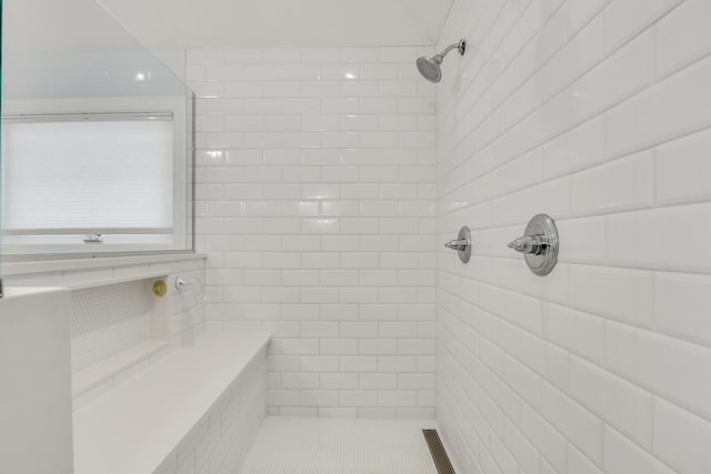 bathroom with tiled shower