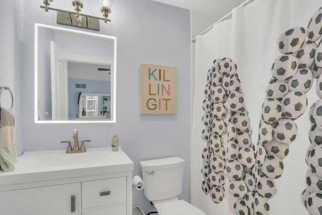 bathroom with vanity, toilet, and walk in shower