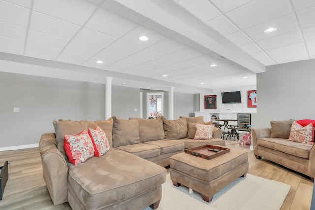 living room featuring a paneled ceiling and light hardwood / wood-style floors