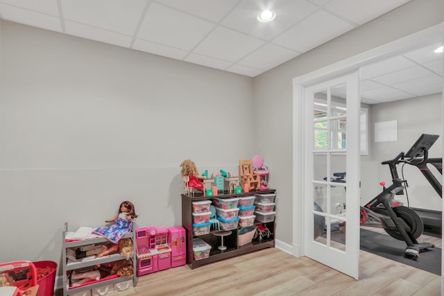 interior space with light wood-type flooring and a drop ceiling