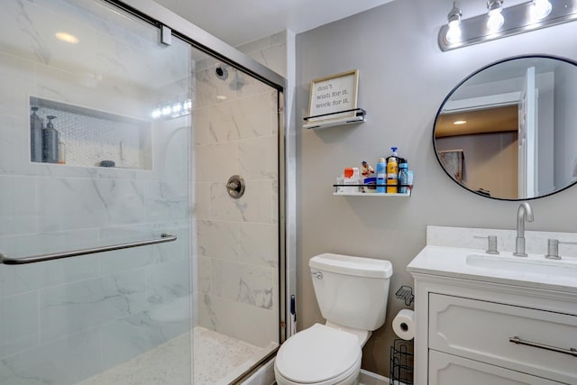 bathroom featuring vanity, toilet, and an enclosed shower