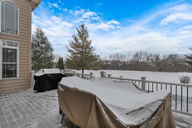 snow covered deck featuring grilling area