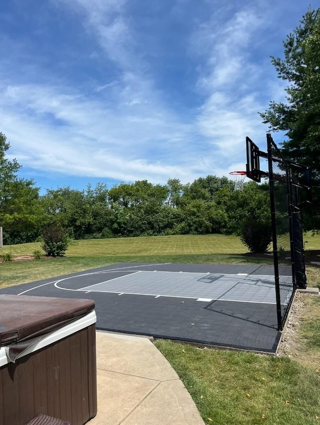 view of sport court with a yard