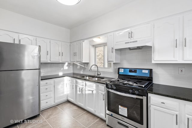 kitchen with white cabinets, appliances with stainless steel finishes, light tile patterned flooring, and sink