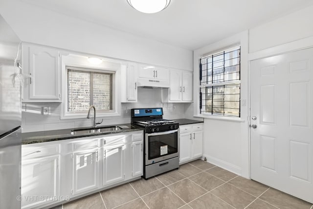 kitchen featuring white cabinetry, sink, light tile patterned floors, and stainless steel appliances