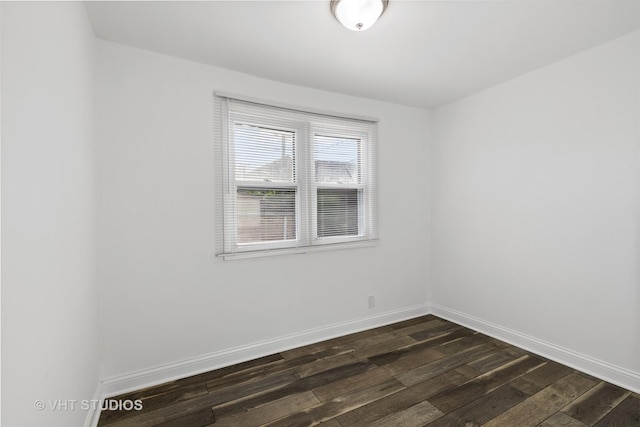 spare room featuring dark wood-type flooring