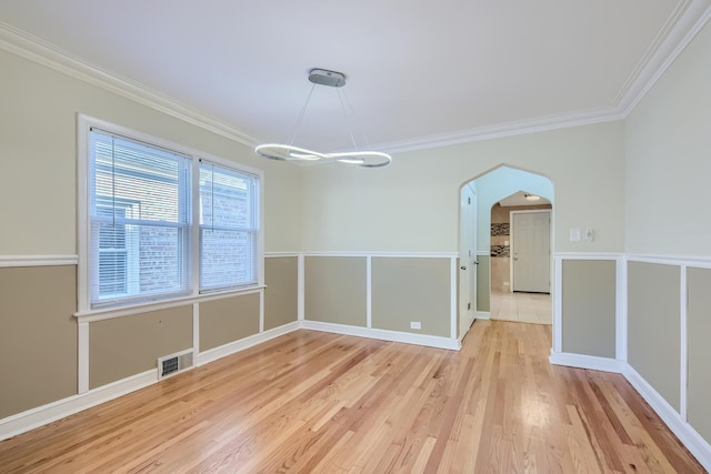 unfurnished dining area featuring light wood-type flooring and ornamental molding