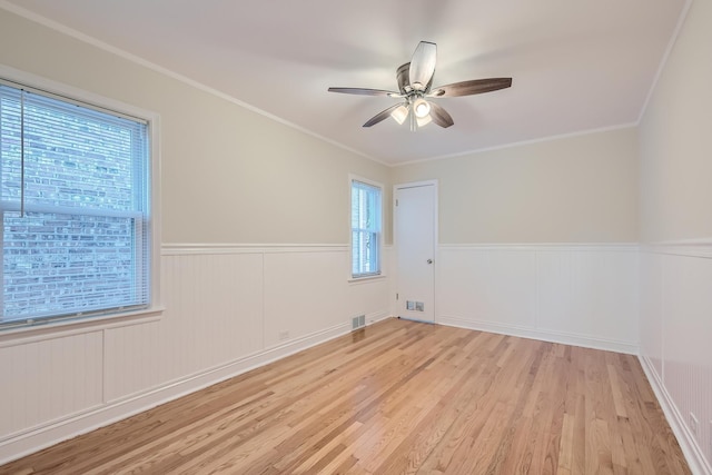 unfurnished room with light hardwood / wood-style floors, ceiling fan, and ornamental molding