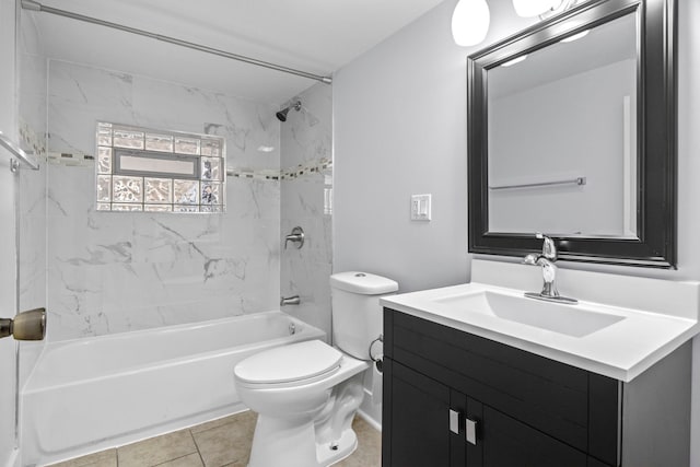 bathroom featuring tile patterned flooring, toilet, vanity, and washtub / shower combination