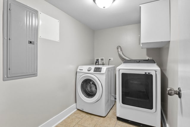 laundry area featuring electric panel, baseboards, separate washer and dryer, and light tile patterned flooring