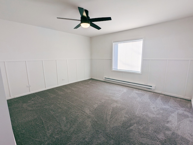 carpeted spare room with ceiling fan and a baseboard heating unit