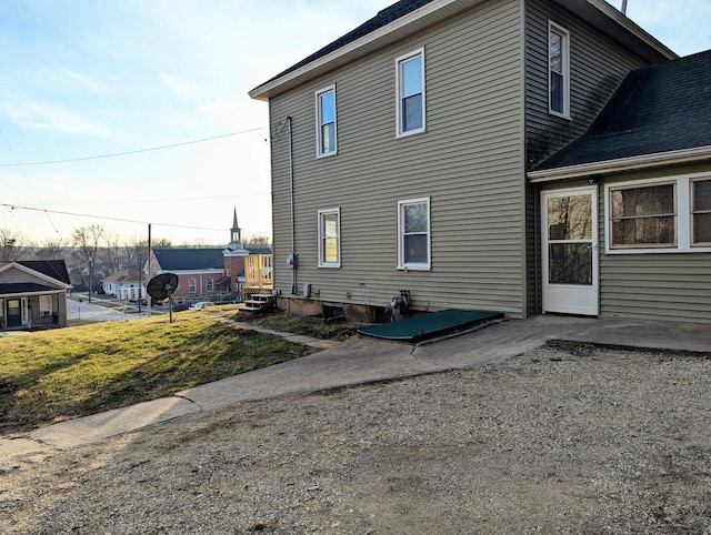 view of home's exterior featuring a patio and a lawn