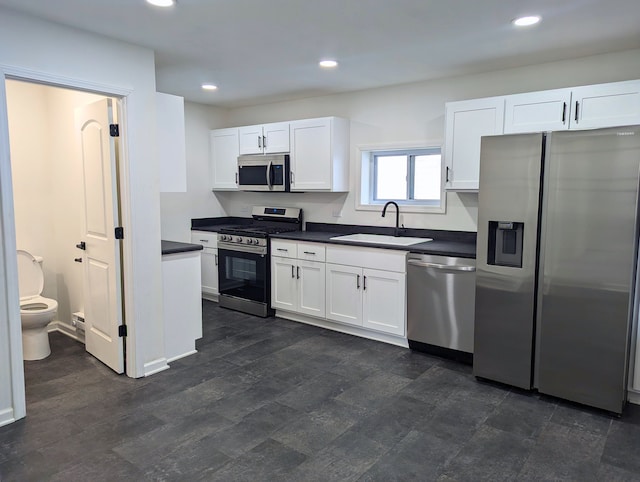 kitchen with sink, stainless steel appliances, and white cabinets